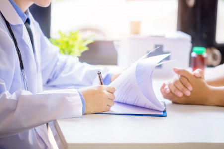 doctor man consulting patient while filling up application form desk hospital 1024x683 1