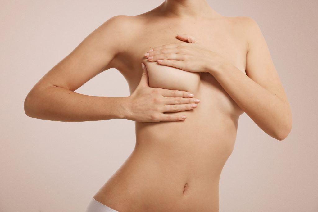 woman checking her breast breast cancer 1024x683 1