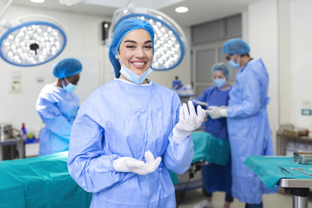 portrait female woman nurse surgeon staff member dressed surgical scrubs gown mask hair net hospital operating room theater