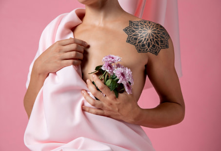 Woman holding flowers over breast